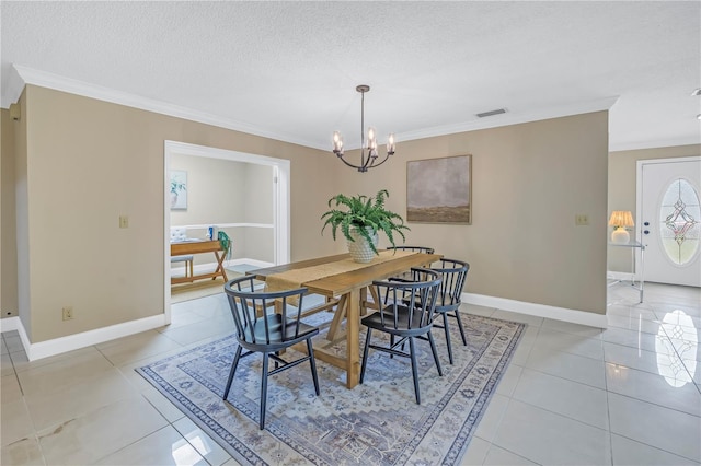 tiled dining space featuring a chandelier, a textured ceiling, and crown molding