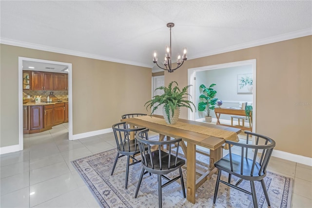 tiled dining room with ornamental molding, a textured ceiling, and a chandelier