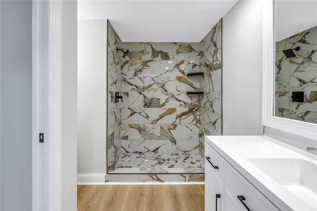 bathroom with a shower, vanity, and wood-type flooring