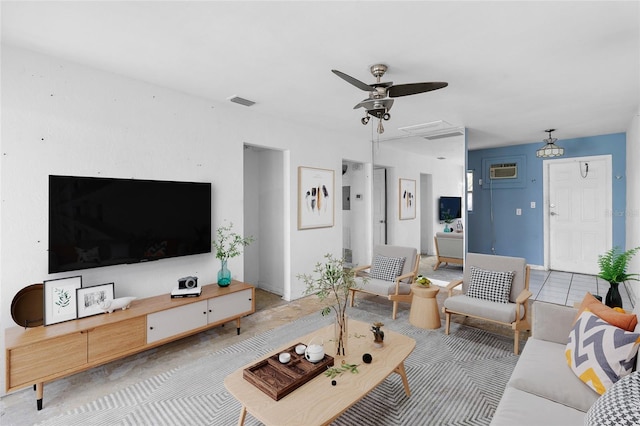 living area with a ceiling fan and a wall mounted air conditioner