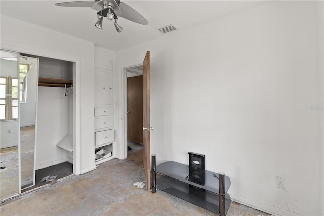 bedroom with concrete floors, a closet, ceiling fan, and baseboards