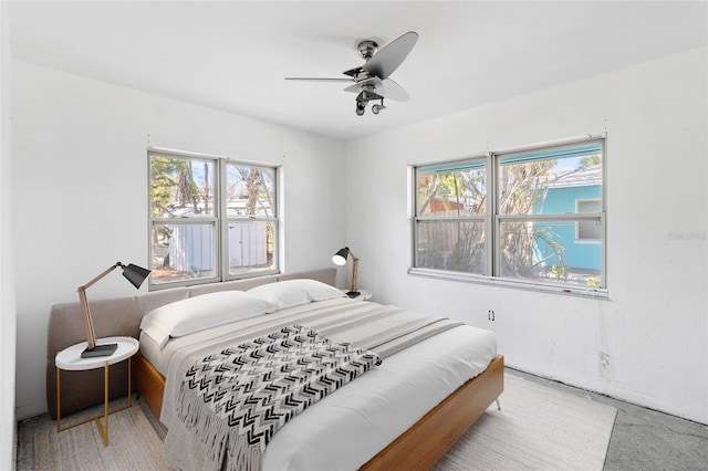 bedroom with multiple windows and a ceiling fan