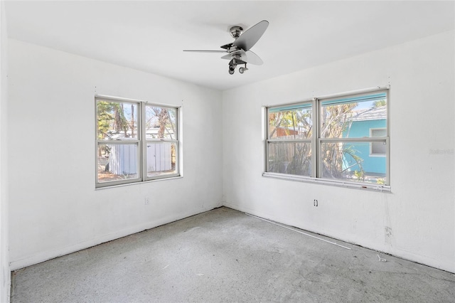 empty room featuring plenty of natural light and a ceiling fan