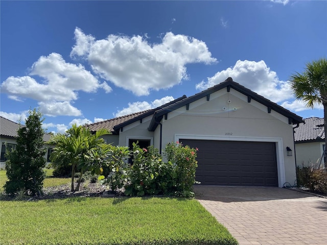 view of front of home with a front yard and a garage