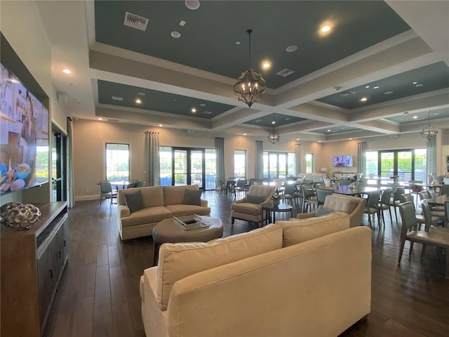 living room featuring coffered ceiling, beam ceiling, dark hardwood / wood-style flooring, and an inviting chandelier