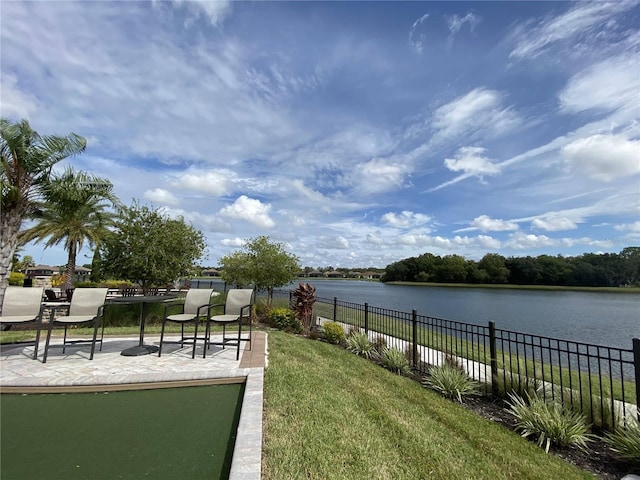 view of yard featuring a patio area and a water view