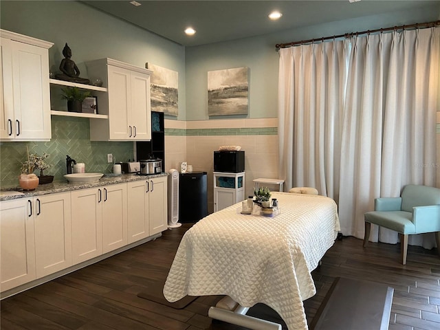 bedroom with dark wood-type flooring