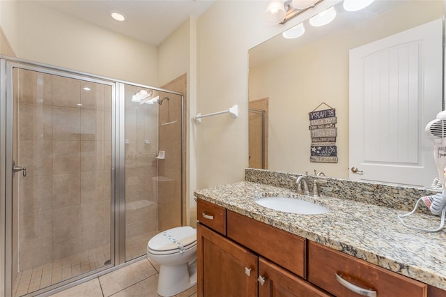 bathroom with tile patterned floors, vanity, toilet, and walk in shower