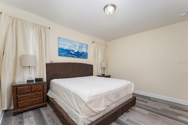 bedroom with wood-type flooring