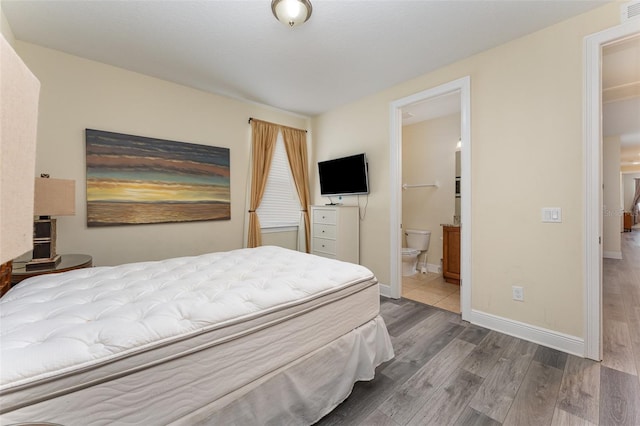 bedroom with wood-type flooring and ensuite bathroom