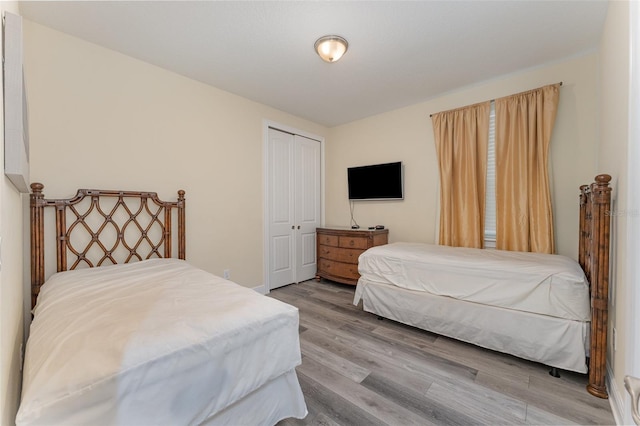 bedroom featuring a closet and light wood-type flooring