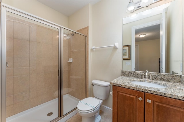 bathroom featuring vanity, toilet, and an enclosed shower