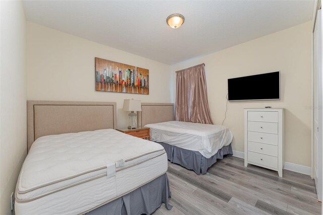 bedroom with light wood-type flooring