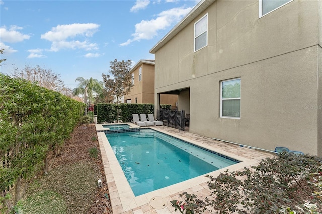 view of pool with an in ground hot tub and a patio