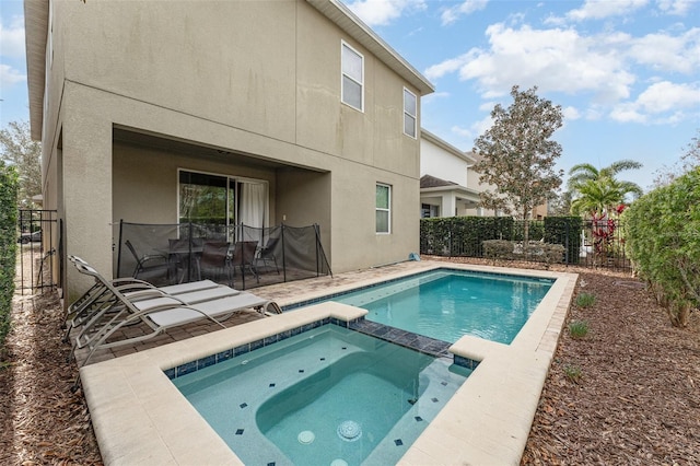 back of property with a patio area and a swimming pool with hot tub