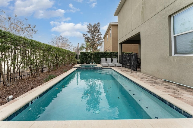 view of pool featuring an in ground hot tub and a patio