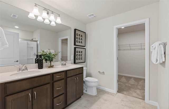 bathroom with an enclosed shower, tile patterned floors, a textured ceiling, toilet, and vanity