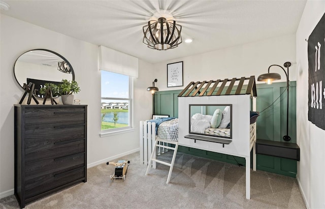 bedroom featuring carpet flooring and an inviting chandelier