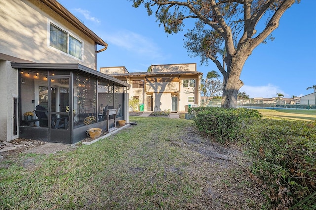 view of yard featuring a sunroom