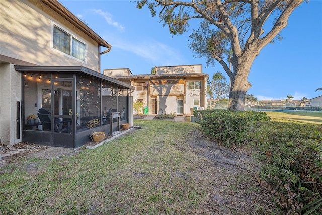 view of yard featuring a sunroom