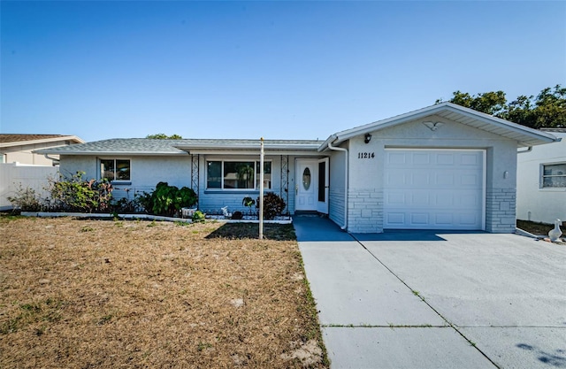 ranch-style home with a front lawn and a garage