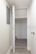 hallway featuring hardwood / wood-style floors and electric panel