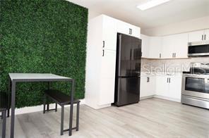 kitchen featuring white cabinetry, light hardwood / wood-style flooring, and stainless steel appliances