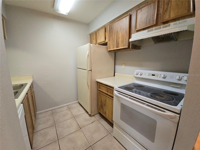 kitchen with sink, light tile patterned floors, and white appliances