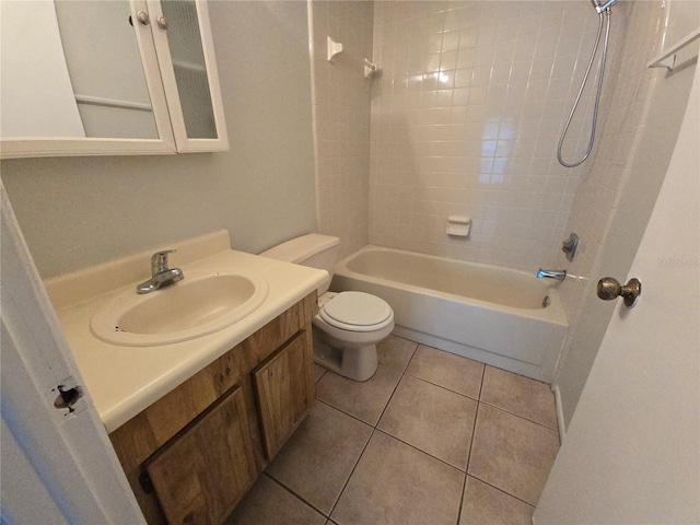 full bathroom featuring toilet, vanity, tile patterned floors, and tiled shower / bath