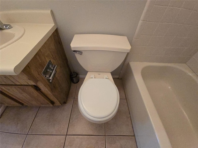 bathroom featuring a washtub, tile patterned flooring, and toilet