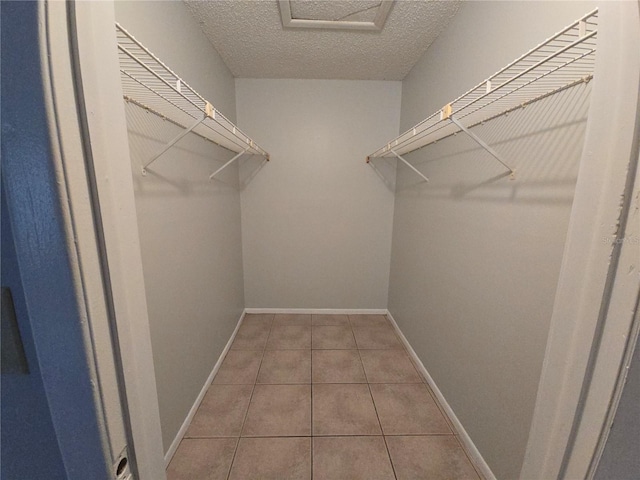 spacious closet with tile patterned flooring