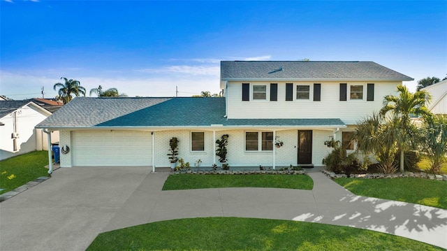 view of front of house with a garage and a front lawn