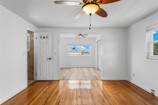8716 Hickorywood Ln, Tampa, FL 33615 - unfurnished room with baseboards, a ceiling fan, and wood finished floors