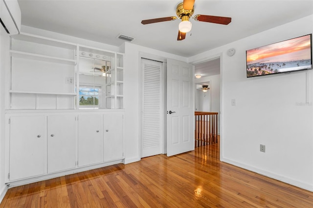 8716 Hickorywood Ln, Tampa, FL 33615 - unfurnished bedroom featuring ceiling fan, visible vents, wood finished floors, baseboards, and a closet