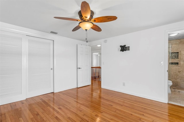 8716 Hickorywood Ln, Tampa, FL 33615 - unfurnished bedroom with connected bathroom, a closet, visible vents, and light wood-style floors
