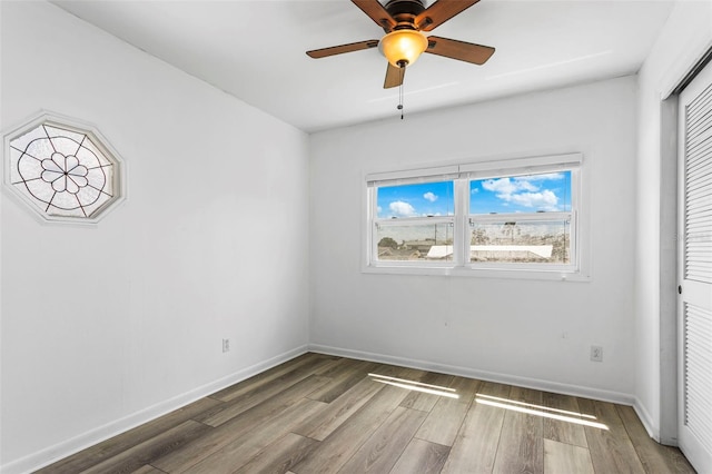 8716 Hickorywood Ln, Tampa, FL 33615 - unfurnished bedroom with baseboards, multiple windows, and wood finished floors