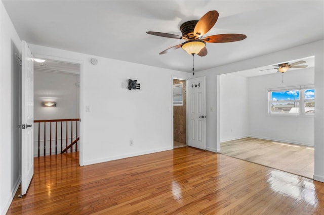 8716 Hickorywood Ln, Tampa, FL 33615 - unfurnished bedroom with baseboards, a ceiling fan, and wood finished floors