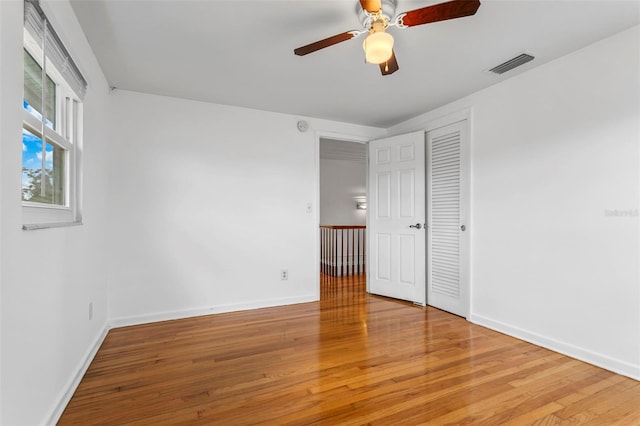 8716 Hickorywood Ln, Tampa, FL 33615 - unfurnished bedroom with baseboards, wood finished floors, and visible vents