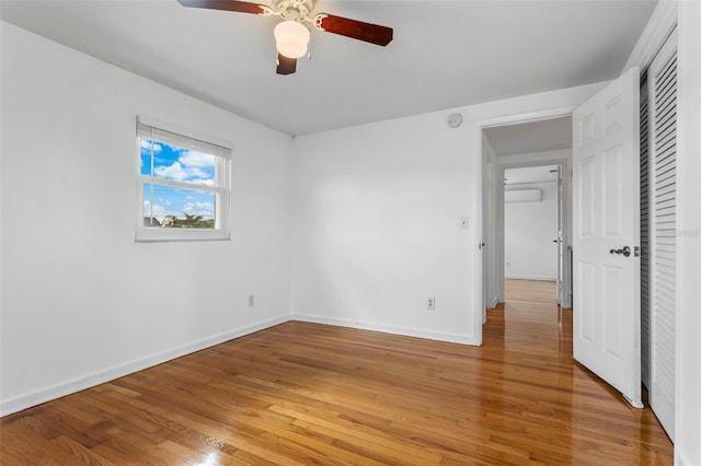 8716 Hickorywood Ln, Tampa, FL 33615 - unfurnished bedroom with baseboards, a ceiling fan, light wood-style flooring, and a closet