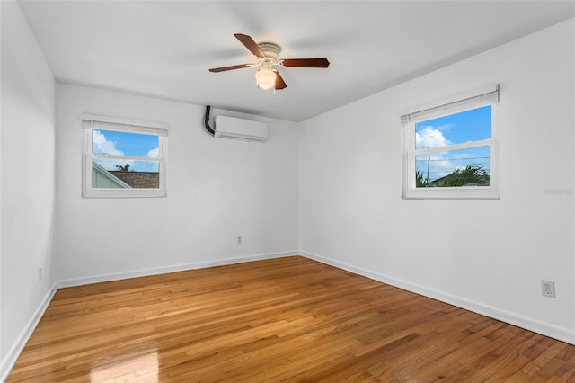 8716 Hickorywood Ln, Tampa, FL 33615 - empty room featuring baseboards, light wood finished floors, and a wall unit AC