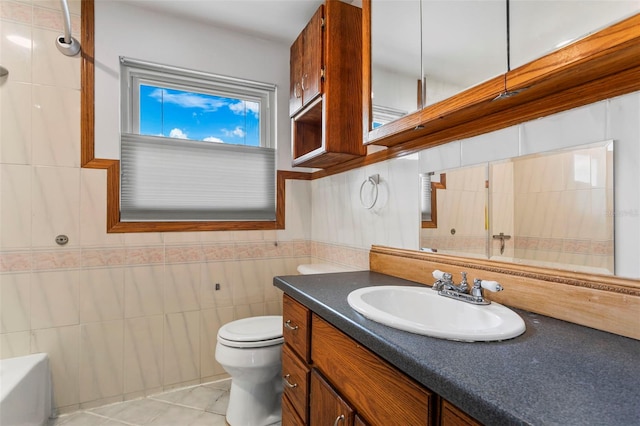 8716 Hickorywood Ln, Tampa, FL 33615 - full bathroom featuring toilet, tile patterned floors, tile walls, and vanity