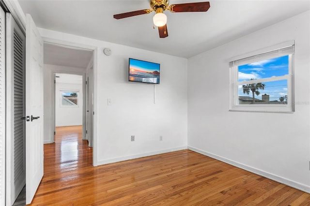 8716 Hickorywood Ln, Tampa, FL 33615 - unfurnished bedroom with baseboards, ceiling fan, light wood finished floors, and a closet