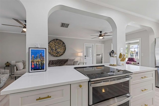 8716 Hickorywood Ln, Tampa, FL 33615 - kitchen featuring a ceiling fan, visible vents, white cabinets, open floor plan, and stainless steel appliances
