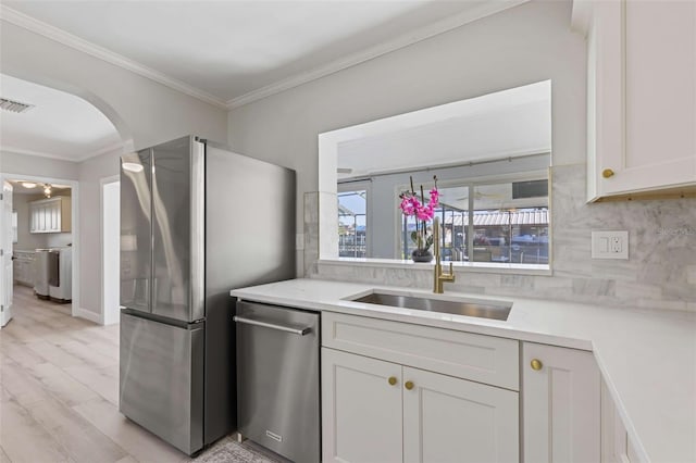 8716 Hickorywood Ln, Tampa, FL 33615 - kitchen with visible vents, crown molding, a sink, light countertops, and stainless steel appliances