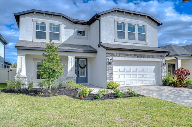 view of front of house with a front yard and a garage