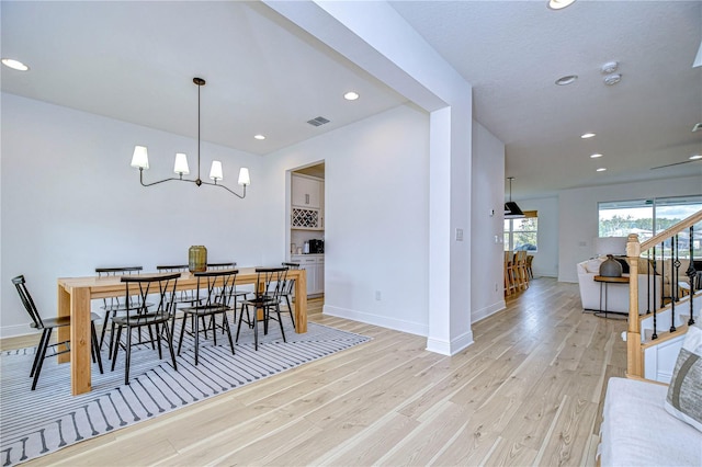 dining room featuring light hardwood / wood-style floors and an inviting chandelier