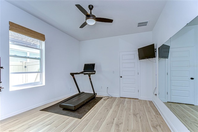 workout area featuring ceiling fan and light hardwood / wood-style floors