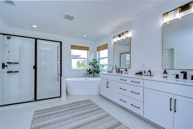 bathroom with tile patterned flooring, vanity, and independent shower and bath