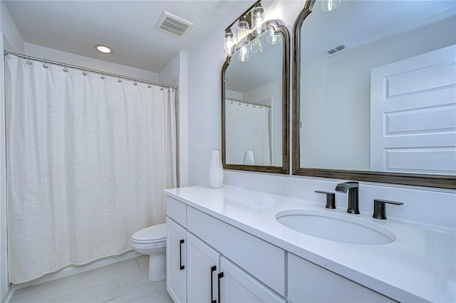 bathroom with tile patterned flooring, vanity, and toilet