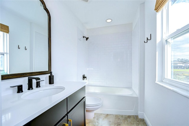 full bathroom with vanity, toilet, and tiled shower / bath combo